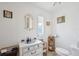 Cozy bathroom featuring a vanity, decorative mirror, toilet, and woven storage baskets at 5646 Cheyenne St, Zephyrhills, FL 33542