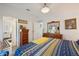 Inviting bedroom with a warm, bright bedspread and classic wooden furniture, exuding a cozy and relaxing atmosphere at 5646 Cheyenne St, Zephyrhills, FL 33542