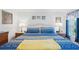 Serene bedroom featuring a bright, patterned bedspread, bedside tables, and a clean, comfortable design at 5646 Cheyenne St, Zephyrhills, FL 33542