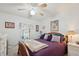 Cozy bedroom featuring a bed, window, side tables with lamps, and artwork on the walls at 5646 Cheyenne St, Zephyrhills, FL 33542