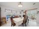Bright dining room boasts natural light and leads to an enclosed, furnished patio at 5646 Cheyenne St, Zephyrhills, FL 33542