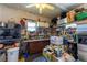 Organized garage featuring a workbench, tools, storage shelves, and various supplies at 5646 Cheyenne St, Zephyrhills, FL 33542