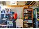 Organized garage featuring shelving units, work sink, and ample storage space at 5646 Cheyenne St, Zephyrhills, FL 33542