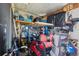 Organized garage featuring a golf cart, golf clubs, bicycles, and ample storage space at 5646 Cheyenne St, Zephyrhills, FL 33542