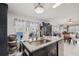 Kitchen island offers a sink and granite countertops and is open to the dining area at 5646 Cheyenne St, Zephyrhills, FL 33542