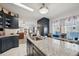 Kitchen island with stainless steel sink and granite countertops adjoins the dining area at 5646 Cheyenne St, Zephyrhills, FL 33542