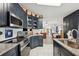Kitchen with stainless steel appliances, granite countertops, and navy blue cabinets at 5646 Cheyenne St, Zephyrhills, FL 33542