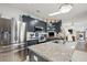 Kitchen features stainless steel appliances, granite countertops, and stylish blue cabinetry at 5646 Cheyenne St, Zephyrhills, FL 33542