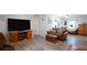 Inviting living room featuring a plush leather sofa, wooden accents, and stylish decor on the wood-look floors at 5646 Cheyenne St, Zephyrhills, FL 33542