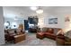 Cozy living room with leather sofas, area rug, open to the eat-in kitchen at 5646 Cheyenne St, Zephyrhills, FL 33542