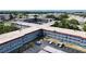 Aerial view of apartment complex with mature trees, landscaping, and parking at 5660 80Th N St # C101, St Petersburg, FL 33709