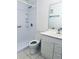 Bright bathroom featuring a shower, toilet, sink, and mirror at 5660 80Th N St # C101, St Petersburg, FL 33709