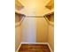 Walk-in closet with wood-look flooring and hanging rods at 5660 80Th N St # C101, St Petersburg, FL 33709