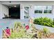 Inviting condo entrance with lovely landscaping, bench, lighting, and a peek at the inside seating area at 5660 80Th N St # C101, St Petersburg, FL 33709
