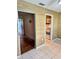 Cozy living space featuring light beige wall coverings, tile floor, and doors to other rooms at 5660 80Th N St # C101, St Petersburg, FL 33709