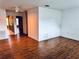 Inviting open-concept living space featuring wood-look flooring and views into the kitchen at 5660 80Th N St # C101, St Petersburg, FL 33709
