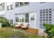 Outdoor patio area featuring seating, a door to the home, and decorative trellis at 5660 80Th N St # C101, St Petersburg, FL 33709