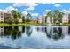 Beautiful pond with fountain surrounded by mature trees and buildings at 5660 80Th N St # C101, St Petersburg, FL 33709