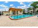 Beautiful community pool with wooden pergola, seating, and lounge chairs at 5660 80Th N St # C101, St Petersburg, FL 33709