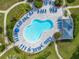 Aerial view of a community pool featuring lounge chairs, umbrellas and shaded area at 6011 Bahia Del Mar Blvd # 158, St Petersburg, FL 33715