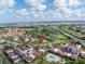 Aerial view showcases condo community with golf course, pool, and lush landscaping near waterfront at 6011 Bahia Del Mar Blvd # 158, St Petersburg, FL 33715
