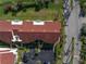 Aerial view of a condo building featuring a red tile roof, landscaped grounds, and convenient parking at 6011 Bahia Del Mar Blvd # 158, St Petersburg, FL 33715