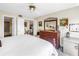 Bright bedroom featuring a wooden dresser with a large mirror, ceiling fan, and access to the bathroom at 6011 Bahia Del Mar Blvd # 158, St Petersburg, FL 33715