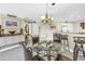 Dining area with chandelier and adjacent bar at 6011 Bahia Del Mar Blvd # 158, St Petersburg, FL 33715