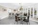 Dining area with mirrored wall, chandelier, and an adjacent kitchen at 6011 Bahia Del Mar Blvd # 158, St Petersburg, FL 33715
