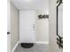 Condo front door, light gray tile, coat hooks, and a decorative mirror at 6011 Bahia Del Mar Blvd # 158, St Petersburg, FL 33715