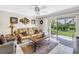 Cozy living room featuring a comfortable sofa, ceiling fan, and sliding glass doors to the outside patio at 6011 Bahia Del Mar Blvd # 158, St Petersburg, FL 33715