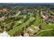 This beautiful aerial image shows a golf course surrounded by trees, homes, and a hotel near a lake at 6150 Gulfport S Blvd # 306, Gulfport, FL 33707