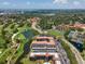 Aerial view of condo complex with green space, golf course, ponds and parking at 6150 Gulfport S Blvd # 306, Gulfport, FL 33707