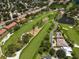 Aerial view of a community with a golf course, ponds, trees, and winding roads at 6150 Gulfport S Blvd # 306, Gulfport, FL 33707