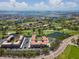 Aerial view of condo complex with golf course, lake, and parking with ocean in background at 6150 Gulfport S Blvd # 306, Gulfport, FL 33707