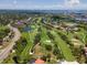 A captivating aerial view showcases the lush golf course, waterfront homes, and scenic surroundings at 6150 Gulfport S Blvd # 306, Gulfport, FL 33707