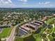 Aerial view of condo complex with a golf course, lake, parking, and landscaping at 6150 Gulfport S Blvd # 306, Gulfport, FL 33707