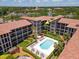 Aerial view showcases Golfview Condominiums courtyard with a sparkling pool and lounge area at 6150 Gulfport S Blvd # 306, Gulfport, FL 33707