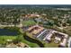 Aerial view of condo complex with mature trees, ponds, parking and nearby recreation areas at 6150 Gulfport S Blvd # 306, Gulfport, FL 33707