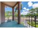 Concrete balcony with black metal railings overlooking a sunny neighborhood at 6150 Gulfport S Blvd # 306, Gulfport, FL 33707