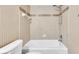Clean bathroom featuring a full tub and shower with patterned tile accents at 6150 Gulfport S Blvd # 306, Gulfport, FL 33707