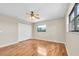 Bedroom with hardwood floors, a ceiling fan, a closet, and windows at 6150 Gulfport S Blvd # 306, Gulfport, FL 33707