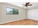 Bedroom featuring modern flooring, bright lighting, and a closet at 6150 Gulfport S Blvd # 306, Gulfport, FL 33707