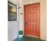 Inviting front entrance featuring a bright red door with classic hardware and sidelight window at 6150 Gulfport S Blvd # 306, Gulfport, FL 33707
