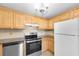 Kitchen with wood cabinets, stainless steel appliances, and granite countertops at 6150 Gulfport S Blvd # 306, Gulfport, FL 33707