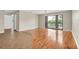Living room showcasing hardwood floors, neutral color palette, and sliding glass doors to the balcony at 6150 Gulfport S Blvd # 306, Gulfport, FL 33707