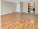 Living room boasts hardwood floors, a neutral color palette, and an open floorplan to the kitchen at 6150 Gulfport S Blvd # 306, Gulfport, FL 33707