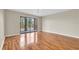 Bright living room with hardwood floors and sliding glass doors to a balcony at 6150 Gulfport S Blvd # 306, Gulfport, FL 33707