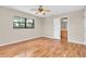 Bedroom with hardwood floors, ceiling fan, and windows with a view to the bathroom at 6150 Gulfport S Blvd # 306, Gulfport, FL 33707
