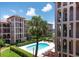 Community pool surrounded by lush landscaping and multi-story buildings at 6150 Gulfport S Blvd # 306, Gulfport, FL 33707